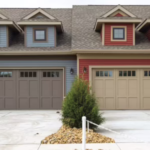 Two 16x7 Courtyard Doors. The one of the left is attached to a blue house and comes in the Terra Bronze finish. The one on the right is attached to a red house and comes in the Sandstone finish.